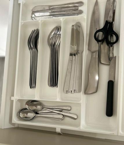 a drawer filled with silver utensils at Lilla huset Bed & Breakfast - countryside guesthouse, free parking in Örebro