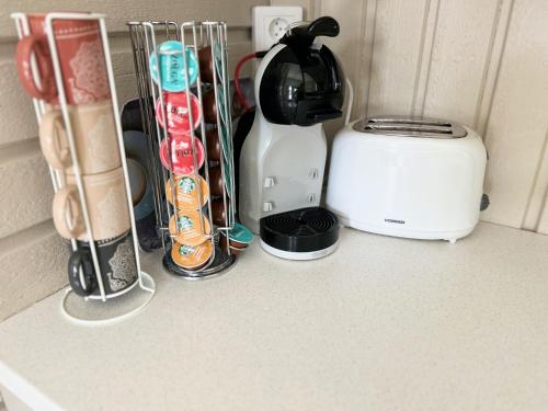 a kitchen counter with a coffee maker and a toaster at Lilla huset Bed & Breakfast - countryside guesthouse, free parking in Örebro