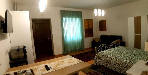 a room with a bedroom with a bed and a couch at Villa Margot in Agropoli