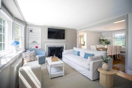 a living room with a white couch and a fireplace at Norwalk Retreat in Norwalk