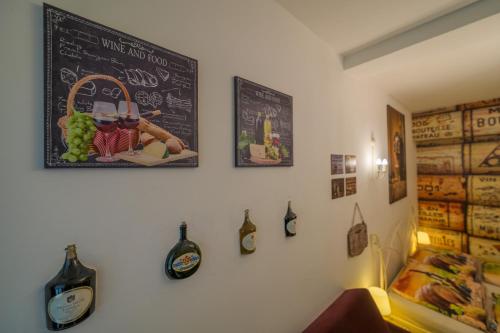 a wall with a chalkboard and some bottles on it at Penzion U Zámku in Mělník