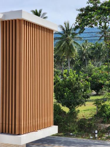 a rendering of a wooden building with trees in the background at เดอะซีน คาบาน่า บีช รีสอร์ท ขนอม The Scene Cabana Beach Resort Khanom in Ban Plau