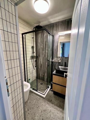 a bathroom with a shower and a sink at Casa Ilinca in Dărmăneşti