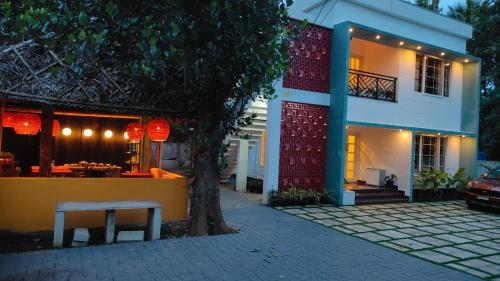 a building with a bench in front of it at Trattorias Holiday Home in Varkala