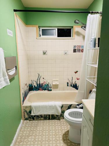 a bathroom with a tub and a toilet at Cozy House Nested Around Trees D in San Jose