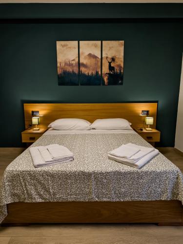 a bedroom with a bed with two towels on it at Borgo dei cervi B&B in Villalago