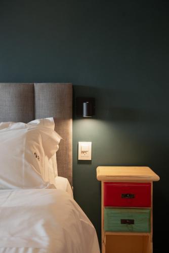 a bedroom with a bed with a red nightstand next to it at Peninsula Petit in San Carlos de Bariloche