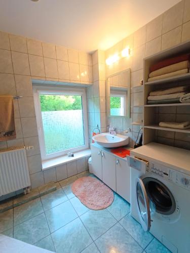 a bathroom with a washing machine and a sink at 109m2 -Apartment Luiza 1- NEW Cottage in Klaipėda