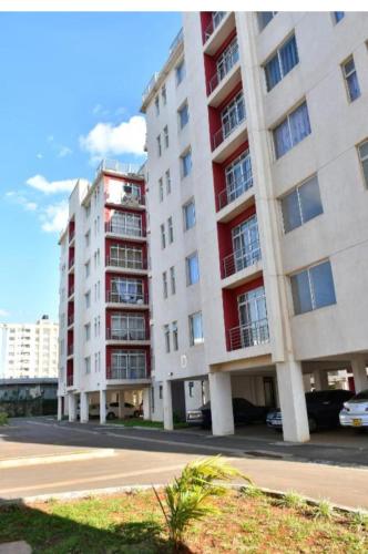 two tall buildings in a city with a street at Racecourse gardens furnished apartments in Nairobi