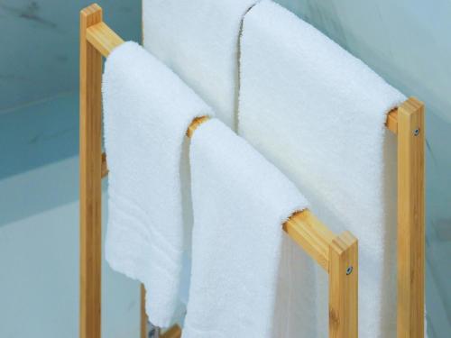 a towel rack with white towels hanging on it at Giardino Dei Principi d'Abruzzo in Citta' Sant'Angelo