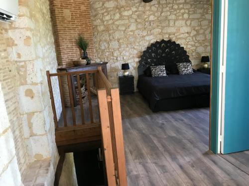 a living room with a staircase and a couch at Logis de Chaumiac in Bouniagues