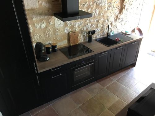 a kitchen with a sink and a counter at Logis de Chaumiac in Bouniagues