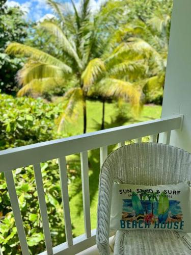 a chair sitting on a porch with a pillow on it at Pacific Ocean Penthouse Suite in Playa Azul