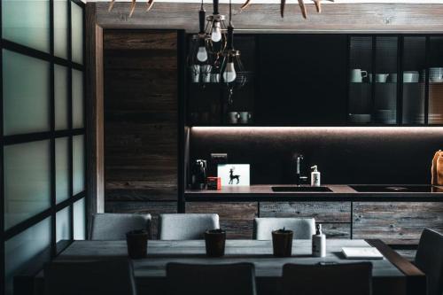 a dining room with a table and a counter at CASA LUMIRA Luxury apartment ski-in ski-out in Breuil-Cervinia