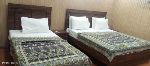 Ein Bett oder Betten in einem Zimmer der Unterkunft Hotel Royal Residency