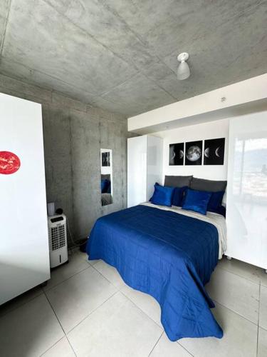 a bedroom with a large blue bed with blue pillows at Serenity spot at iFreses to lovelystay in Curridabat
