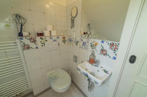 a small bathroom with a sink and a toilet at Penzion U Zámku in Mělník