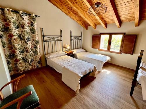 Postel nebo postele na pokoji v ubytování RAPIA Casa Rosa 1