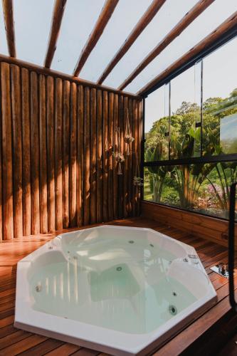 a jacuzzi tub in a room with a window at La Nostra Terra in Nova Veneza