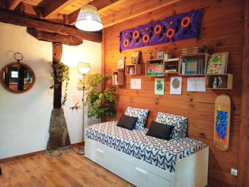 a room with a bed with a skateboard on the wall at Aldaetxea in Biáñez