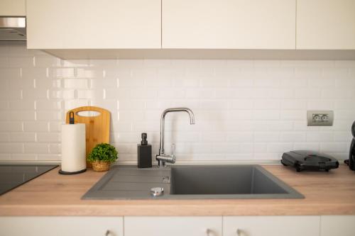 a kitchen counter with a stainless steel sink at AirVista Apartments in Antimácheia