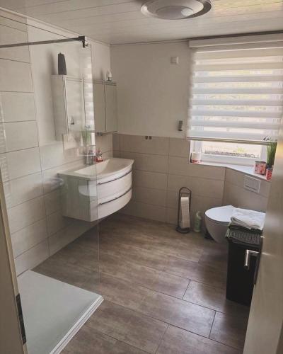 a bathroom with a tub and a sink and a toilet at Ferienwohnung WerraLiebe in Bad Sooden-Allendorf