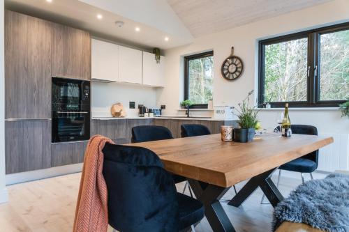 a kitchen and dining room with a wooden table and chairs at Drumhierny Woodland Hideaway in Leitrim