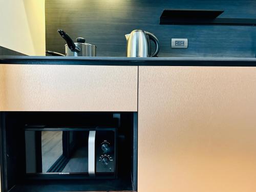 a kitchen with a counter top with an oven at Edge Central Pattaya By YoYo in Pattaya Central