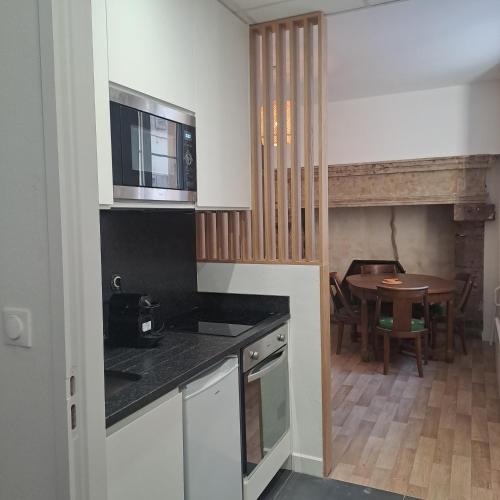 une cuisine avec une table et une salle à manger dans l'établissement La chambre des notaires, à Moulins