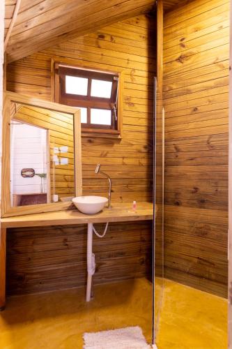 a bathroom with a sink and a mirror at Hostel Da Vila Ilhabela in Ilhabela