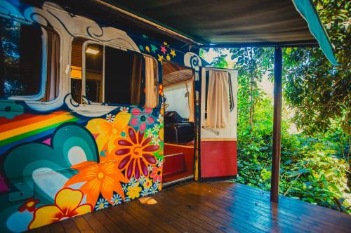 an open door of a bus with flowers painted on it at Hostel Da Vila Ilhabela in Ilhabela