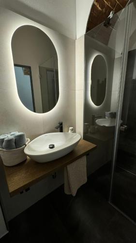 a bathroom with a sink and a mirror at Family Apartments Černice in Mojné