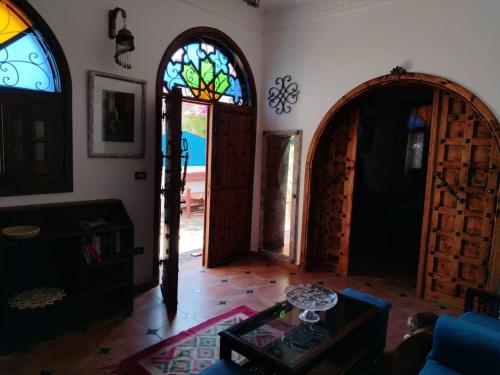 a living room with two doors and a table at Villa Andalusia Dahab blue in Dahab