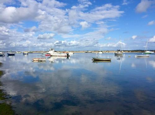 a group of boats sitting in a body of water at Meublé de Tourisme 4 étoiles avec Jacuzzi & Sauna in Mios