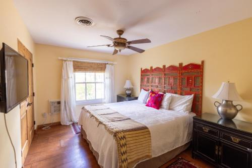 a bedroom with a bed and a ceiling fan at Casa Blanca Inn and Suites in Farmington