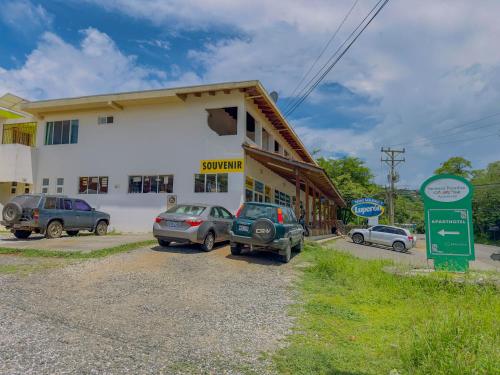 a building with cars parked in front of it at Hermosa Paradise in Playa Hermosa
