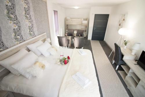 a living room with a white couch and chairs at Aparthotel "Queen Zina" in Vlasic