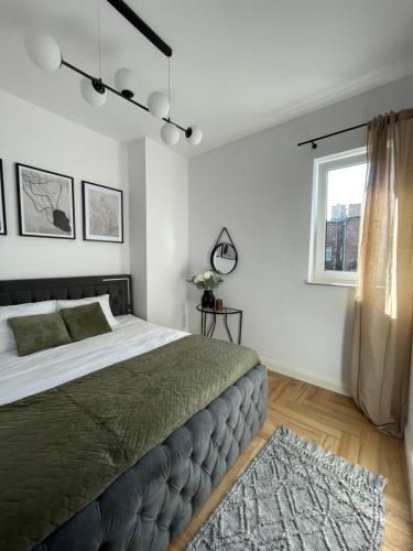 a bedroom with a large bed and a window at Aleja 12 in Częstochowa