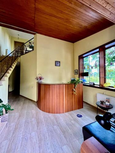 a living room with a staircase and a table at Guest House Lotus in Tʼelavi