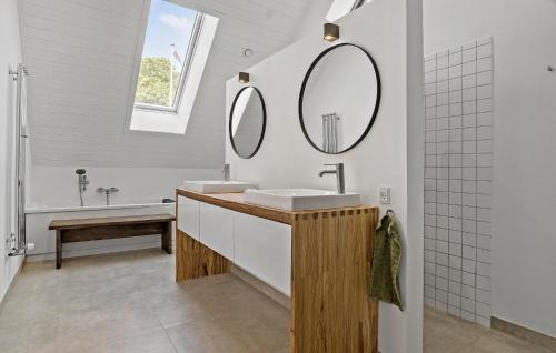 a bathroom with a sink and two mirrors at 3 Bedroom Beautiful Apartment In Samsø in Onsbjerg