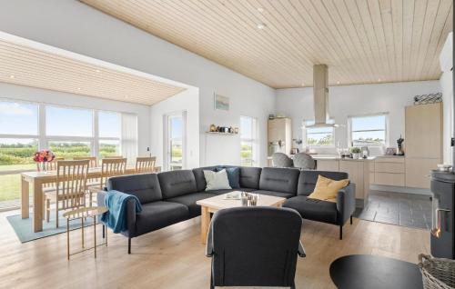 a living room with a couch and a table at Lovely Home In Tarm With Wifi in Tarm