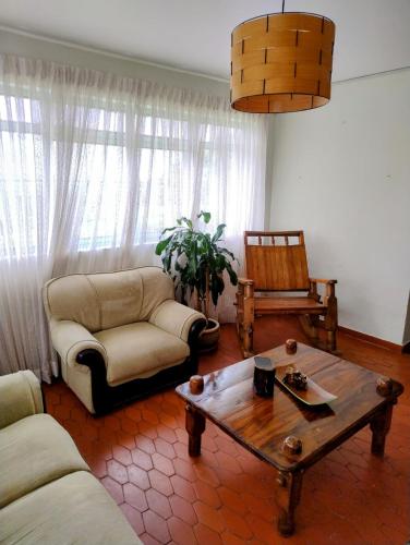 a living room with a couch and a coffee table at Finca Hotel Santa Clara in Calarcá