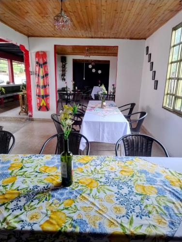a room with a table with a blue and yellow table cloth at Finca Hotel Santa Clara in Calarcá