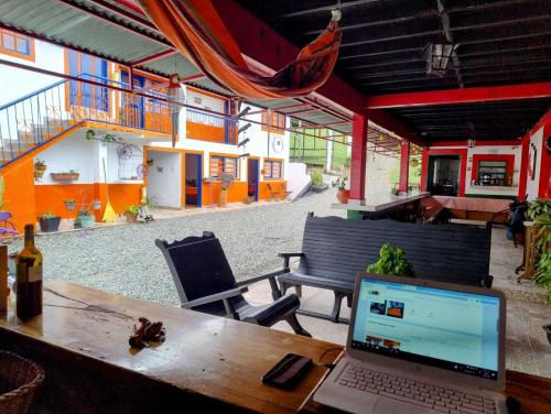 a laptop computer sitting on a wooden table on a patio at Finca Hotel Santa Clara in Calarcá