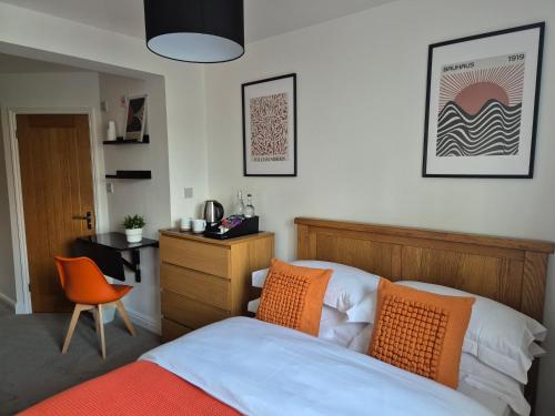 a bedroom with a bed and a desk and a chair at Carolines rooms in Cherry Hinton