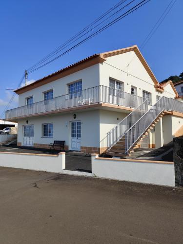 a white house with a staircase in front of it at Vista de Sonho in Calheta