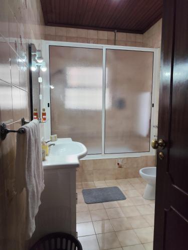 a bathroom with a sink and a toilet at Vista de Sonho in Calheta
