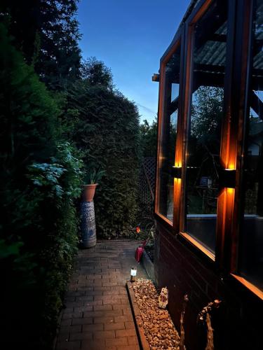 a brick walkway with a window and a potted plant at Bungalow Jersleber See bei Magdeburg in Wolmirstedt