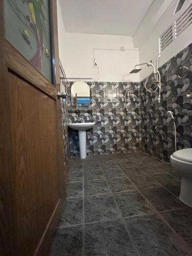 a bathroom with a sink and a toilet at Eleven Thalalla in Talalla South