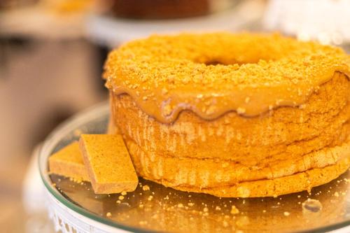 a close up of a cake with a piece of butter at Hotel Britannia in Penedo